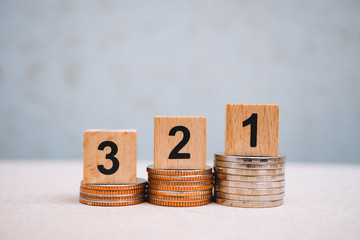 Wooden block number one two three on stack coins using as business and financial concept