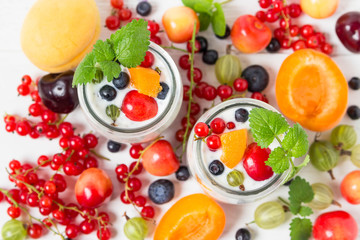 Vegan yogurt chia seeds  on white table with berries.