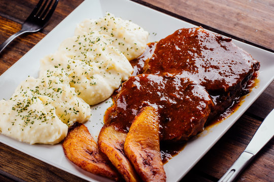 Asado negro with mashed potatoes and fried plantain