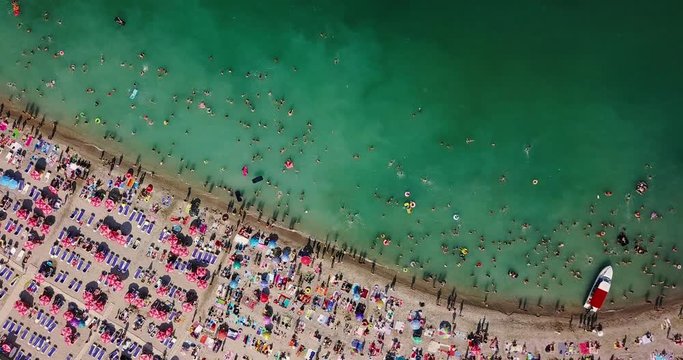 Aerial View From Flying Drone Of People Crowd Relaxing On Beach In Romania At The Black Sea