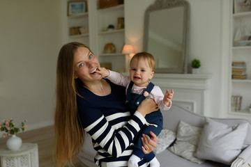 Happy parents playing with child at home