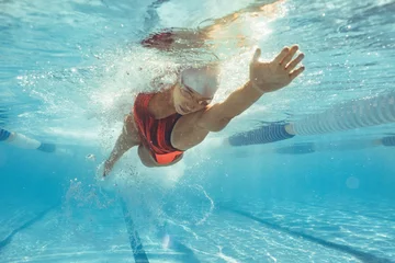 Fotobehang Female athlete swimming in pool © Jacob Lund