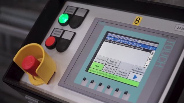 Cnc machine touch controls. Remote Panel Of Print Machine With Red Button. Clip. Hand of worker, modern equipment. Innovative engineering solutions. close-up of the control panel in the shop for