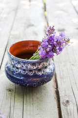 A bouquet of fresh cut lavender with tableware Gzhel