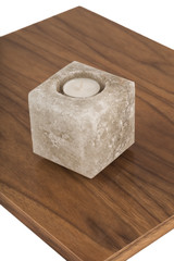 Candlestick made of natural salt on varnished coating, reflection of objects.