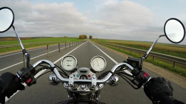 4K. Motorcycle riding on the beautiful road under blue sky, wide point of view of rider. Classic cruiser/chopper forever! 