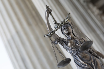 The statue of justice Themis or Iustitia, the blindfolded goddess of justice against an ionic order...