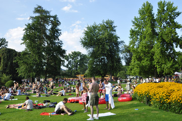 Sumertime at the boarder of lake Zürich: Masses of peoples relaxing, grilling and enjoying the...
