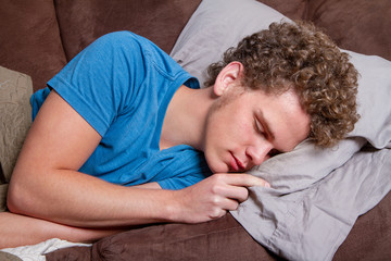 man passed out on the couch during the day