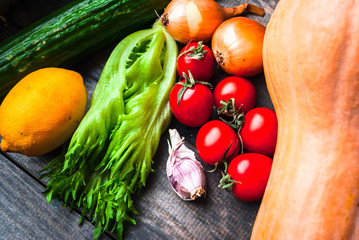 Rustic style wooden table full of fresh bright raw vegetables