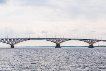 Road bridge over the Volga river between Saratov and Engels, Russia. Cloudy summer day.