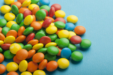 Close up of colorful candies on blue background