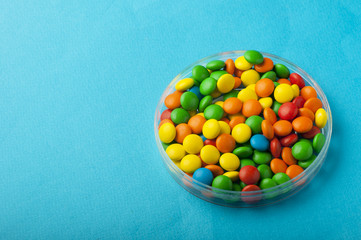Close up of colorful candies on blue background