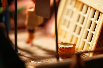 Miniature figure model scene of cloth basket on rooftop house model.