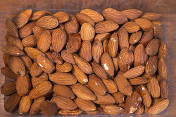 Pile of almonds in the plastic box