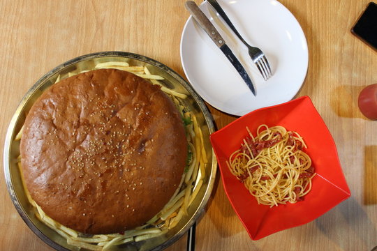 Big Burger With Spaghetti And Empty Plate