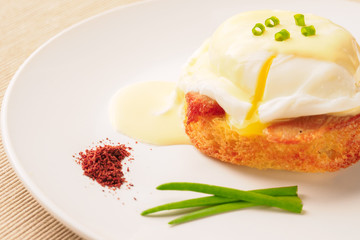 Breakfast is Eggs Benedict - toasted English muffins, bacon, ham, poached eggs, herbs and delicious buttery hollandaise sauce.