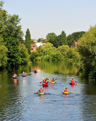 Group of people kayaking and canoeing down a river