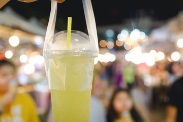 canesugar water drinking with market blurred in background