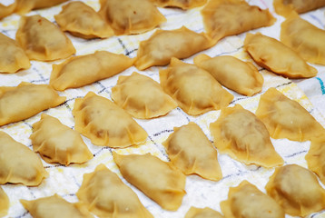 Traditional Polish homemade dumplings called pierogi - variety with mushrooms and cabbage
