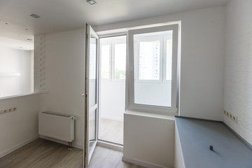 Empty tiled kitchen with dish stainless steel appliances