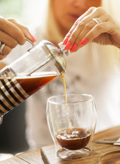 Pouring filter coffee in glass, detail artistic, soft focus