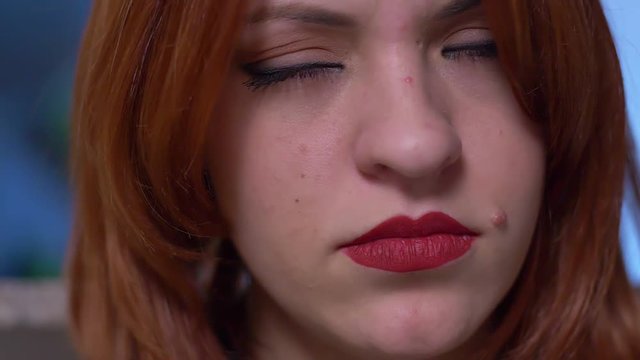 sad and sulky sensual woman closes her eyes - macro - slow motion