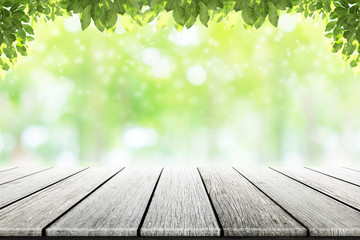 Empty wooden table  with beautiful garden background blurred.