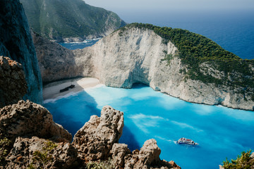 Fototapeta na wymiar Navagio beach or Shipwreck bay with turquoise water and pebble white beach. Famous landmark location. Landscape of Zakynthos island, Greece