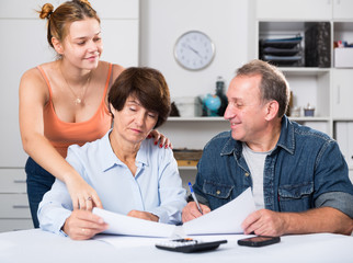 Adult couple is singing contract with their daughter