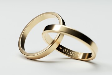 Isolated golden wedding rings with date 1. July