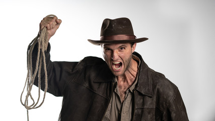 a man in an old hat screams and shows aggression.