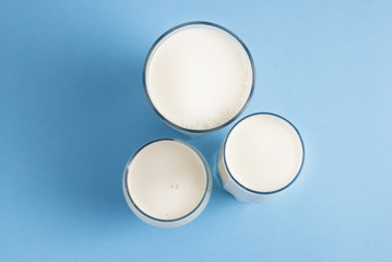 Three glasses Milk Drink Dairy Products Lactose Isolated Blue Background Top View
