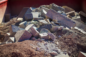 container in the city with construction debris