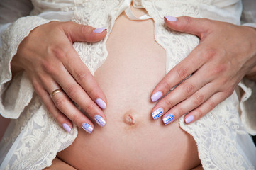 pregnant mummy keeps a tummy with a child, a loving mother is waiting for a child, the family is...