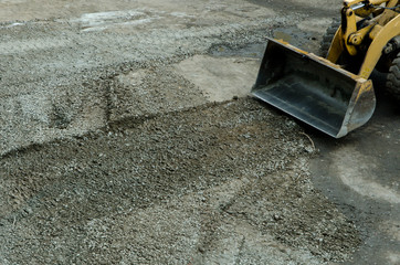 the tractor is leveling the road from the stones