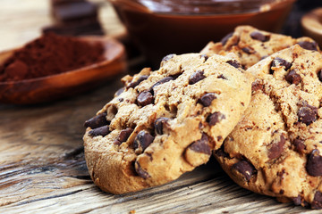 Chocolate cookies on table. Chocolate chip cookies shot with chocolate