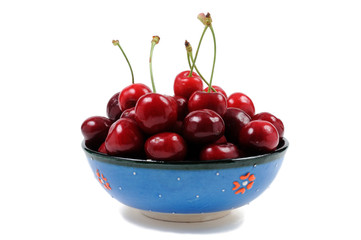 Ripe cherry in a plate on a white background. Front view.