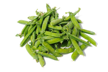 Green peas in sticks on a white background. View from above.