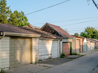Assortment of diverse garages tightly spaced on an urban laneway