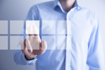 Businessman pressing virtual buttons in concept
