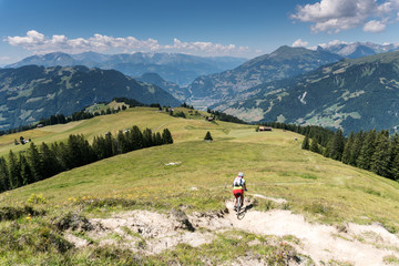 Fototapeta na wymiar retired senior citizens mountain bike in an idyllic alpine landscape in Switzerland near Klosters