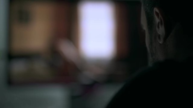 blurred man alone at home looking porn movie.Sex addiction