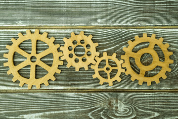 Wooden gears on a wooden background. mechanism interaction, creativity, teamwork.