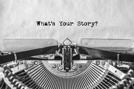 What's Your Story? the text is typed on an old typewriter. tell your stories. close-up