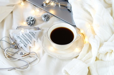 Obraz na płótnie Canvas Fflat lay Christmas background. Xmas composition of New Year's Christmas balls ,cup of coffee , and laptop. Winter holiday concept.Home working lifestyle in a bed.