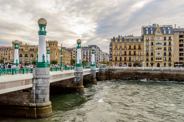 Fototapeta premium City view of San Sebastian or Donostia with a bridge and water at the front and baroque buildings at the back