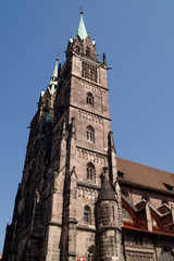 Fototapeta na wymiar Saint Lawrence cathedral on the blue sky background. Medieval gothic church in Nuremberg, Bavaria, Germany
