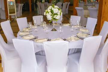 table in the restaurant, served, lots of chairs, large company