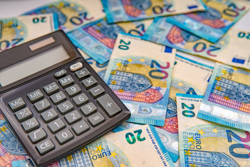 Close up of a calculator and euro money in a financial analyzing concept